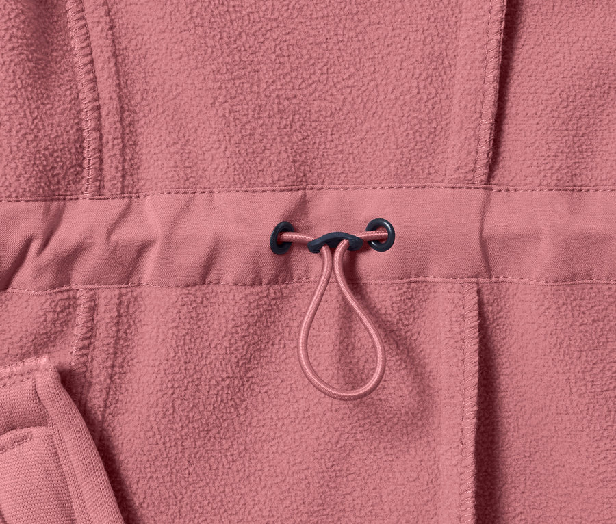 Gros plan sur un manteau softshell rose avec cordon de serrage à la taille.