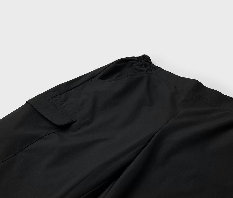 Gros plan sur un pantalon noir avec poche et taille élastique.