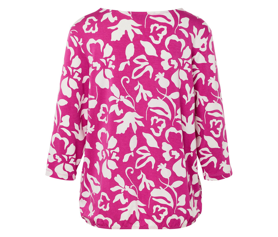 Vue arrière d'un haut rose à motif floral blanc.