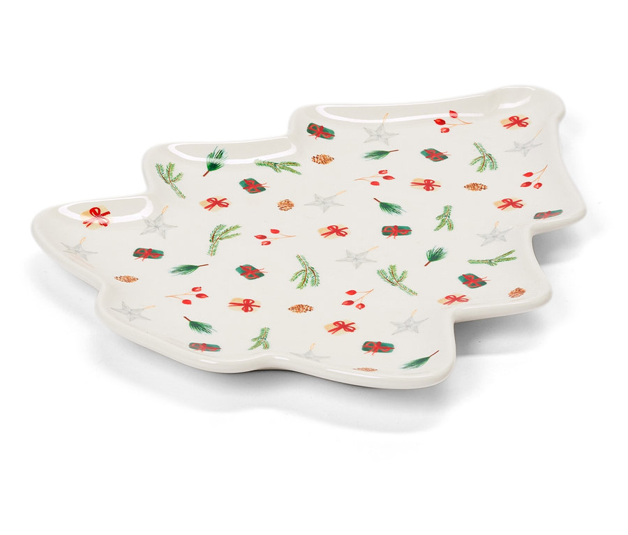Assiette blanche en forme de sapin de Noël avec motifs de Noël.
