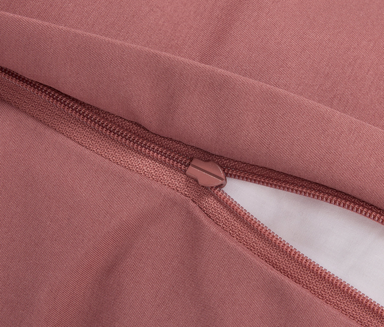 Détail d'une housse de couette rose avec fermeture éclair.