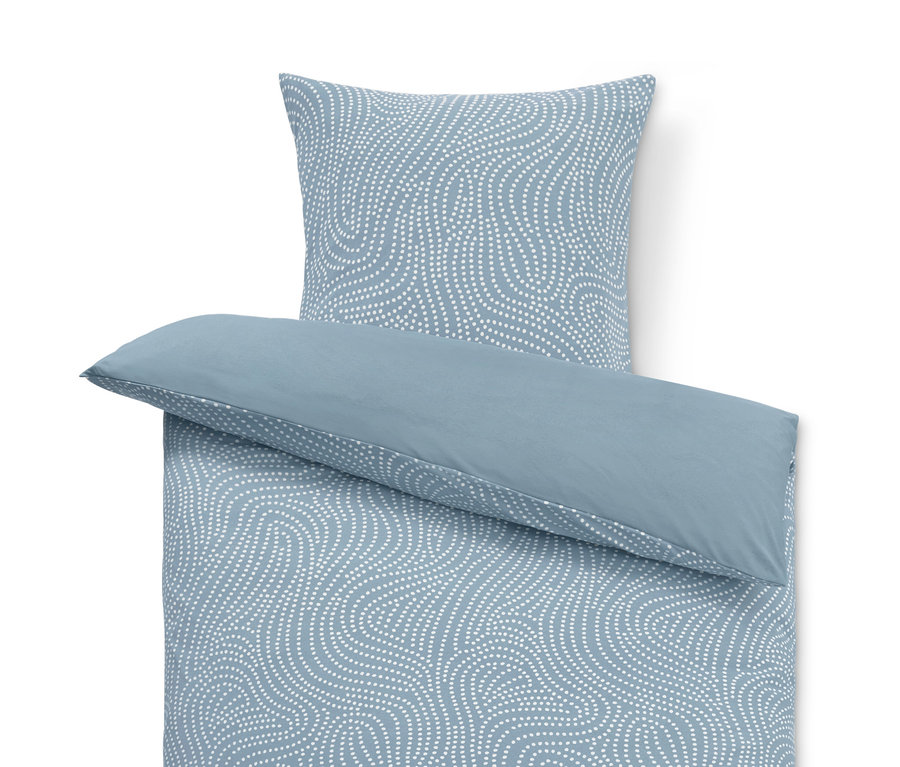 Parure de lit en jersey d'hiver bleu clair avec motif à pois blancs.