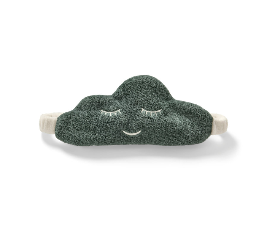 Un masque de nuit en forme de nuage vert avec un visage souriant sur un fond blanc.