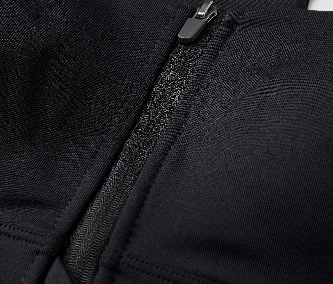 Gros plan d'un soutien-gorge de sport noir avec fermeture éclair sur le devant.