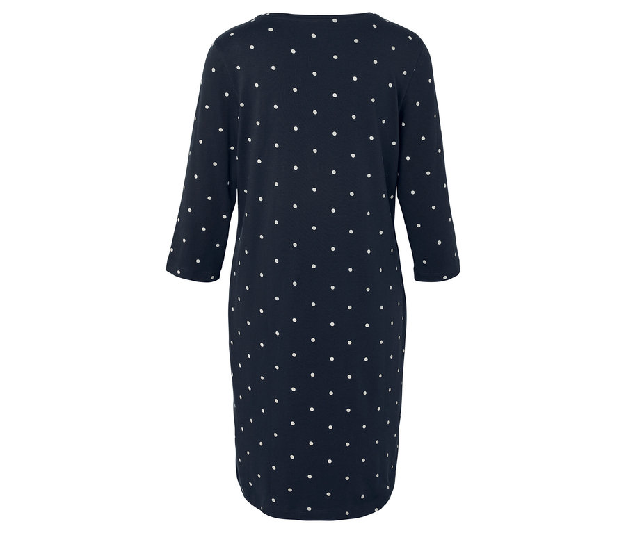 Vue arrière d'une robe bleu marine à pois blancs avec des manches trois-quarts.