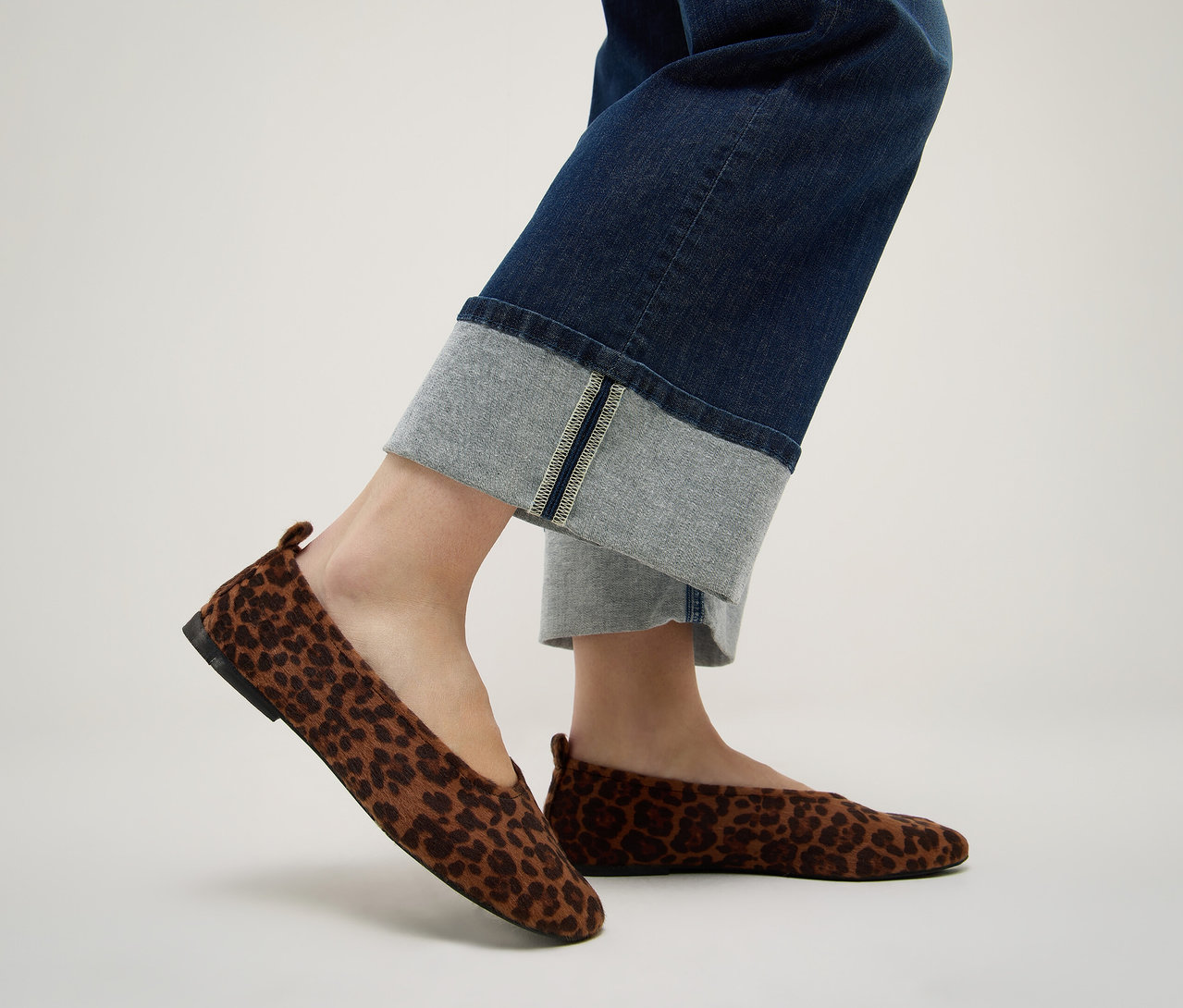 Pieds portant un jean bleu foncé Angels Denim «
Laia Turn-Up
», Wide Leg, et des ballerines marron à motif léopard.