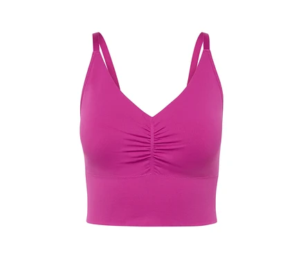 Gros plan d'une brassière de sport rose avec de fines bretelles.