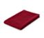 Une nappe jacquard rouge pliée sur un fond blanc.