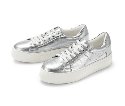 Deux sneakers à plateau en cuir argentés sont placés côte à côte sur un fond blanc.