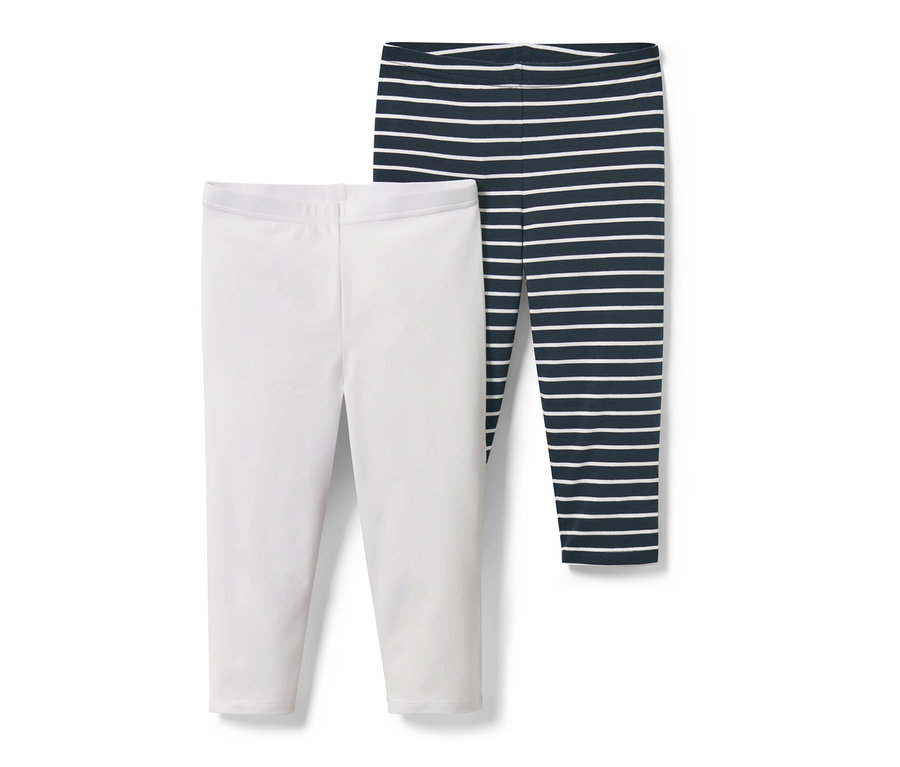 Deux leggings 3/4 pour enfant : un blanc uni, un rayé bleu et blanc.