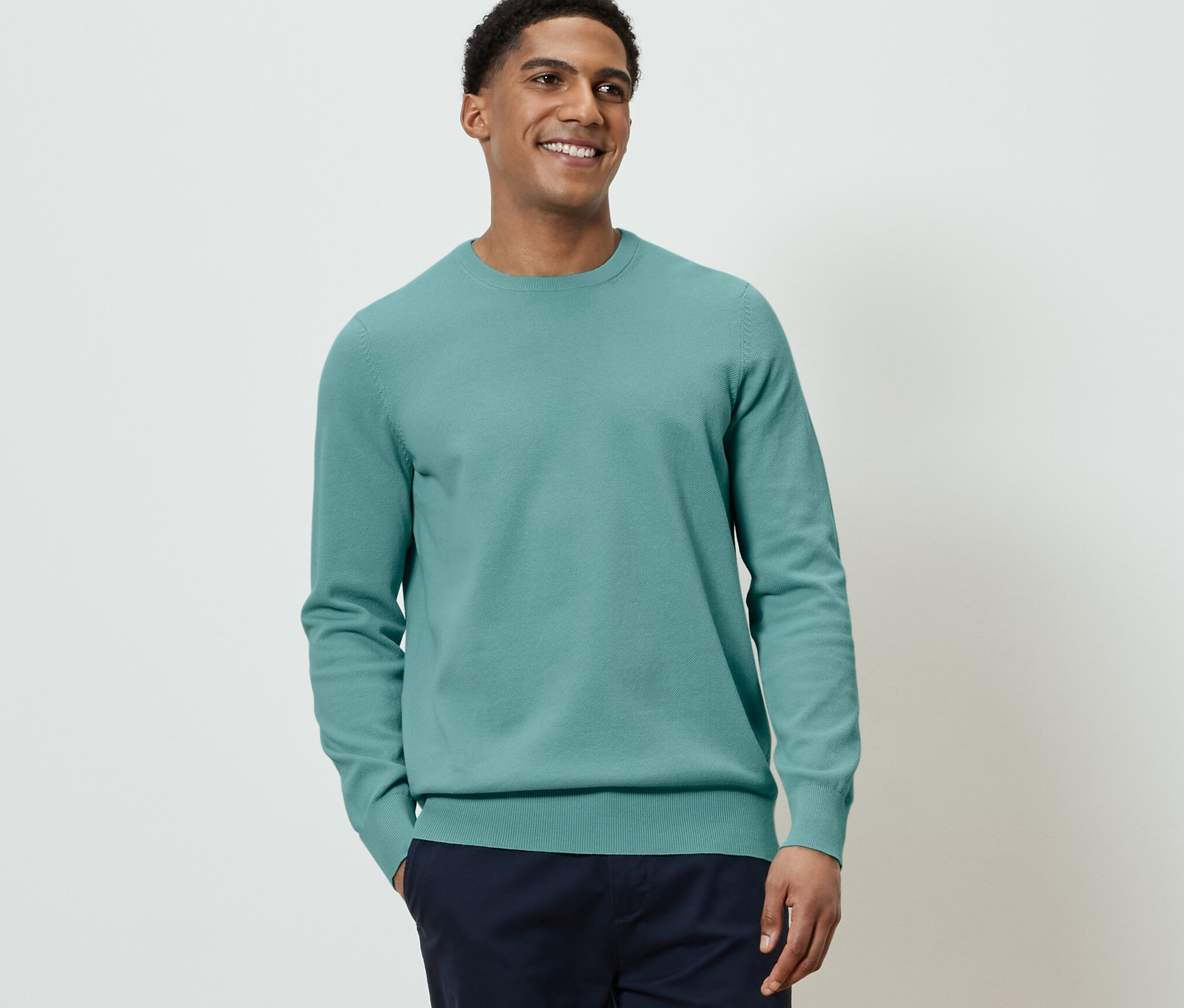 Un homme portant un pull en maille.