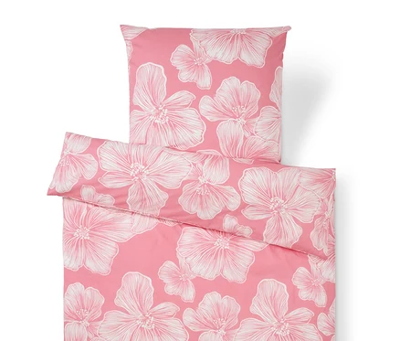 Literie rose avec des fleurs blanches.