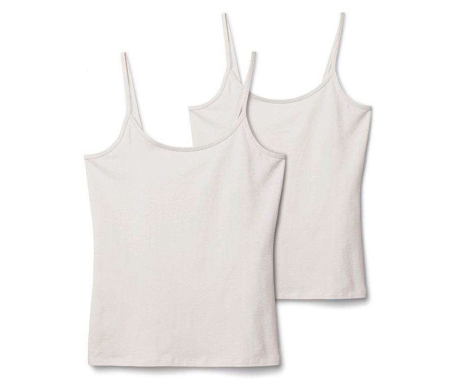 Deux débardeurs blancs à fines bretelles sont posés côte à côte sur un fond blanc.