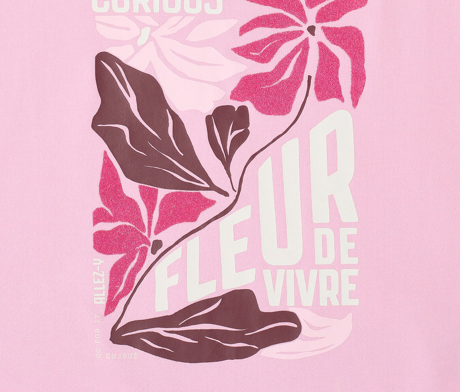 Gros plan sur un t-shirt à motif CECIL avec un motif floral et le mot CURIOUS.