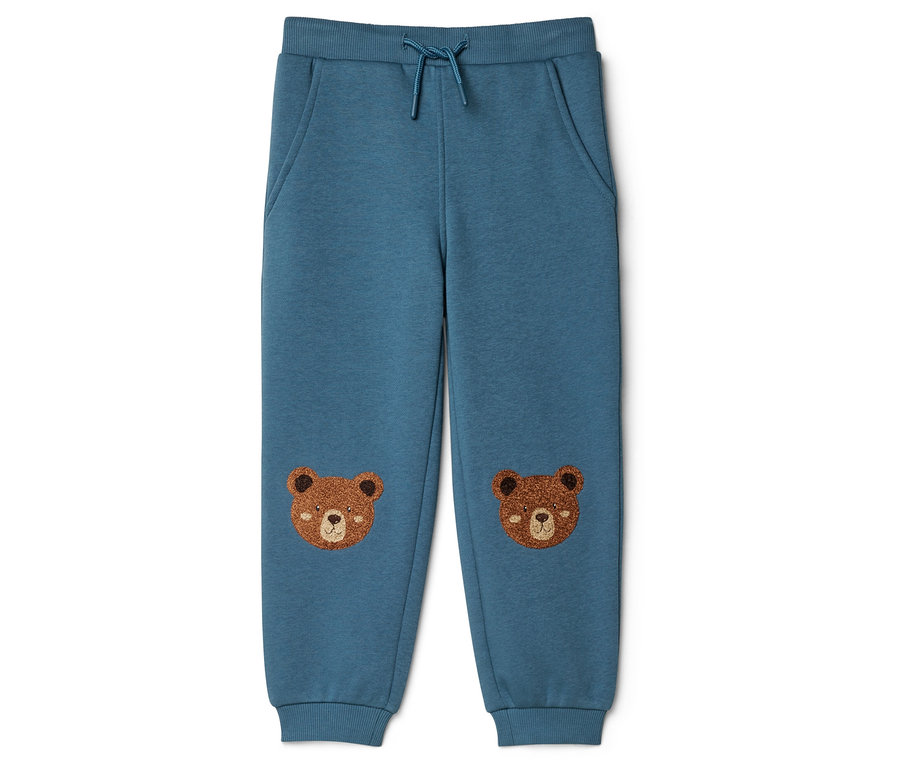 Pantalon de jogging enfant turquoise avec cordon de serrage, poches et deux visages d'ours bruns brodés sur les genoux.