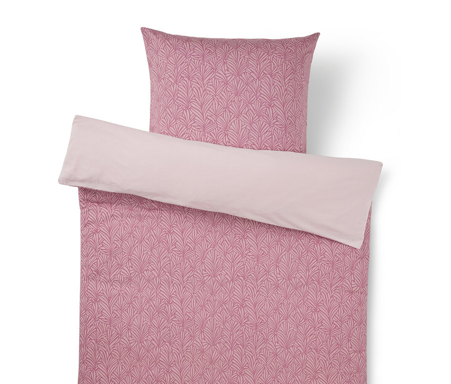 Parure de lit rose avec motif de feuilles et revers rose clair.