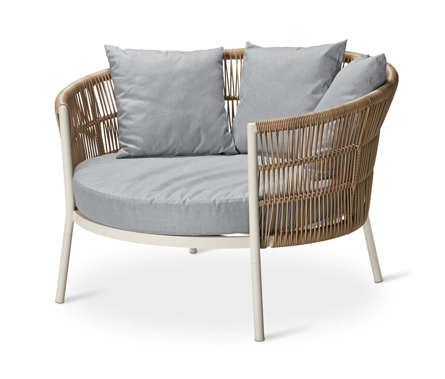Un fauteuil de jardin « Liska » avec un tressage en rotin beige et des coussins gris.