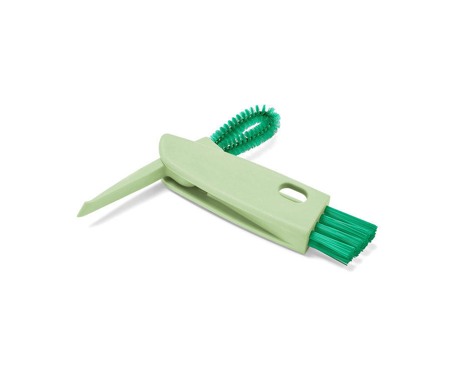 Une brosse multifonction 3 en 1 verte sur un fond blanc.