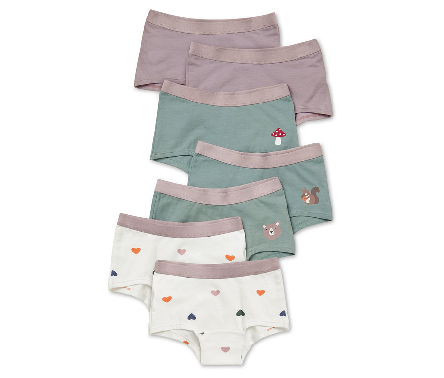 Cinq slips pour filles lilas, verts et blancs avec des motifs de cœurs, de champignons, d'écureuils et d'ours.