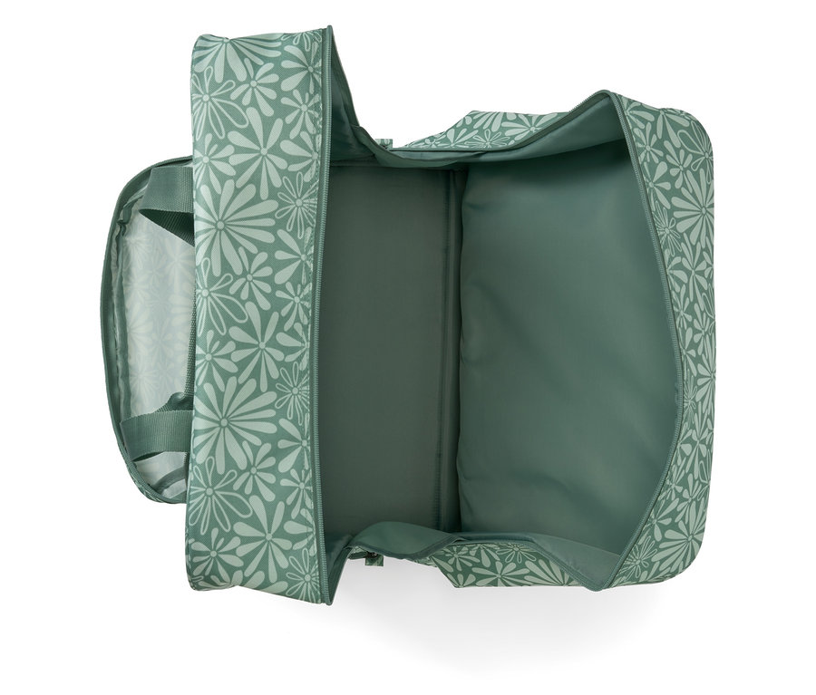 Sac pour machine à coudre ouvert avec un motif floral vert.