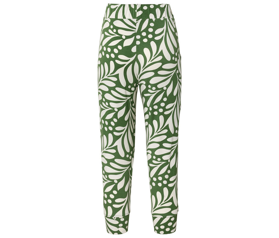 Pantalon avec un fond vert et un motif blanc de feuilles et de points.