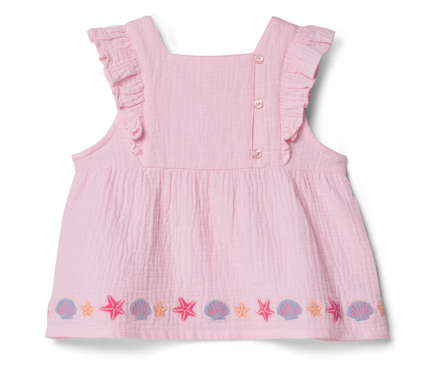 Haut rose sans manches avec des volants et un motif d'étoile de mer et de coquillage sur l'ourlet.