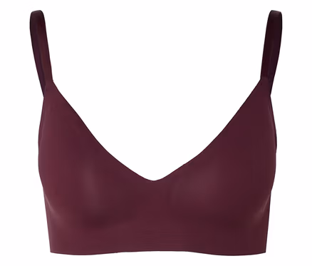 Soutien-gorge bordeaux à col en V et fines bretelles sur fond neutre.