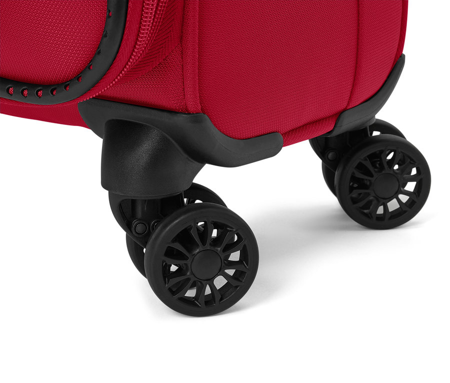 Gros plan sur les roulettes noires d'une valise rouge.