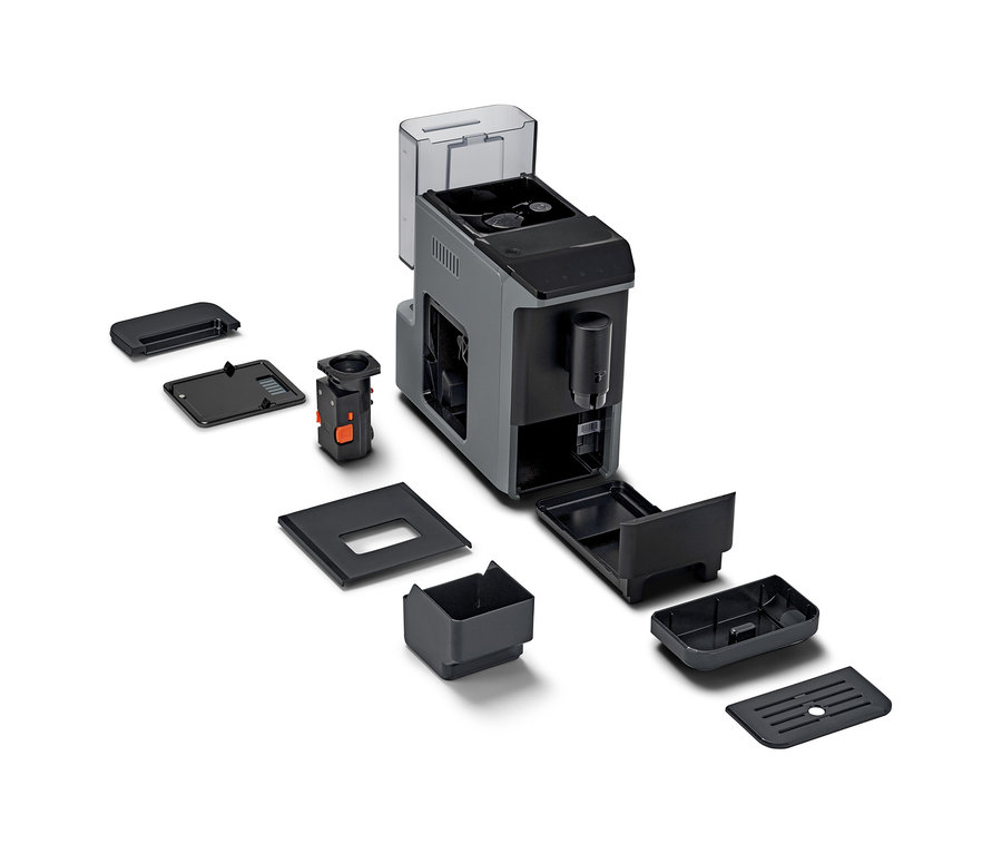 Un « Esperto mini » démonté et ses pièces détachées sur fond blanc.