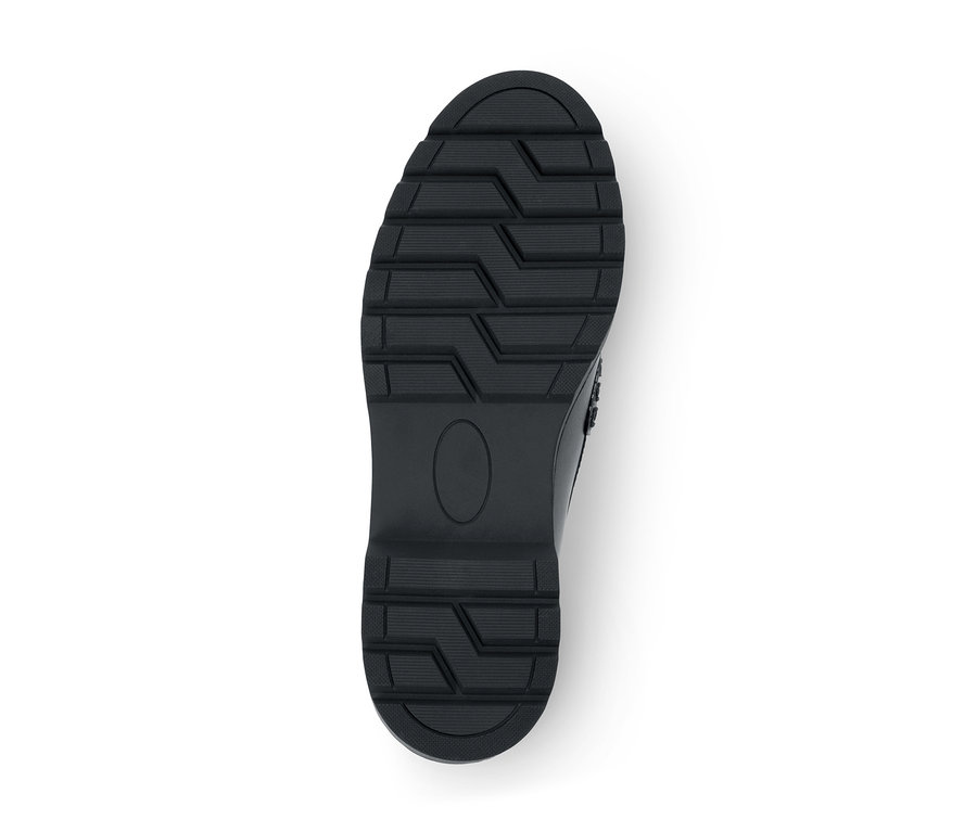 Semelle de chaussure noire avec une bande de roulement profonde et une zone ovale lisse au centre.
