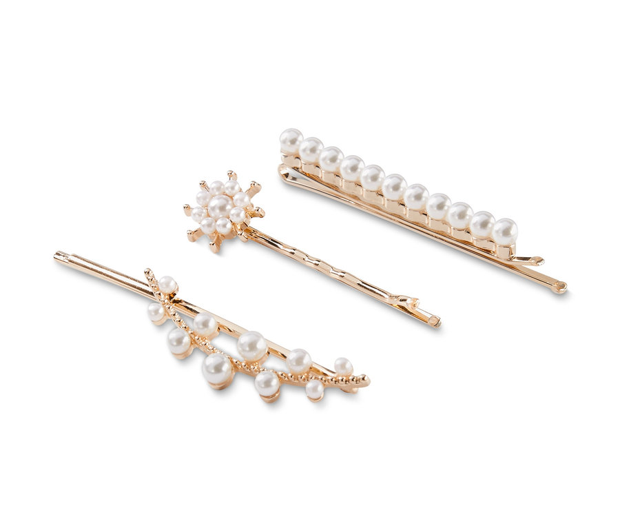 Lot de trois barrettes dorées avec des perles sur fond blanc.