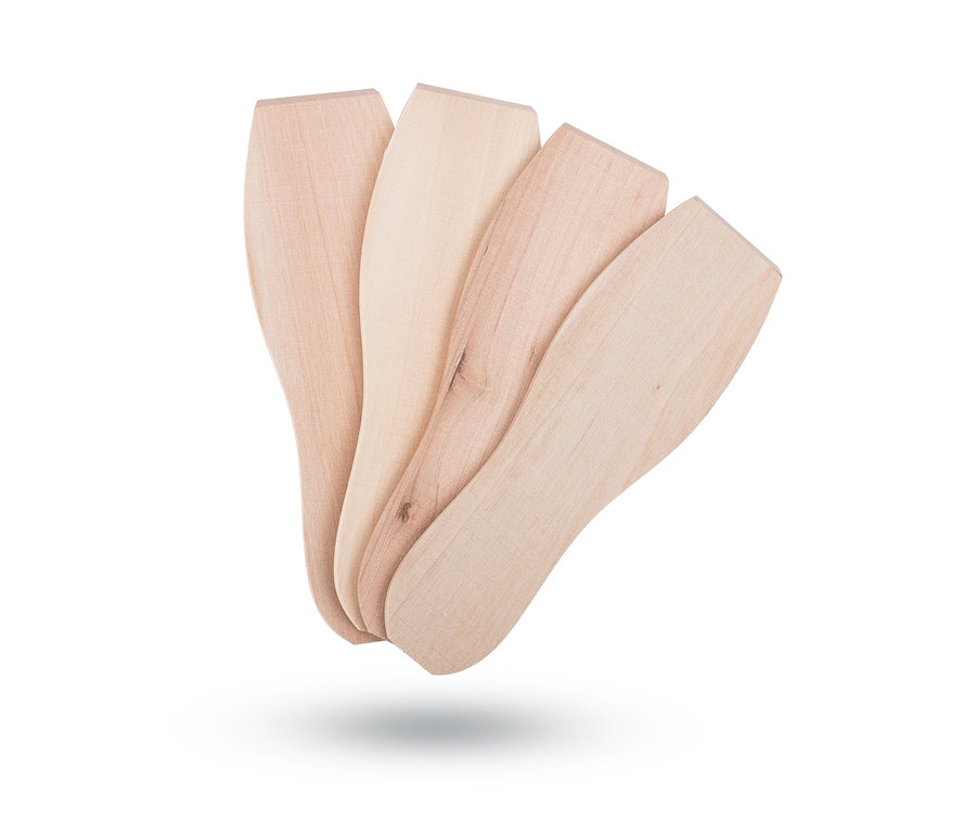 Quatre spatules en bois sont posées les unes à côté des autres.