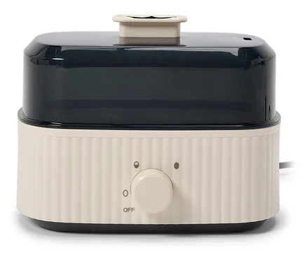Cuiseur vapeur blanc avec récipient transparent noir et bouton rotatif.