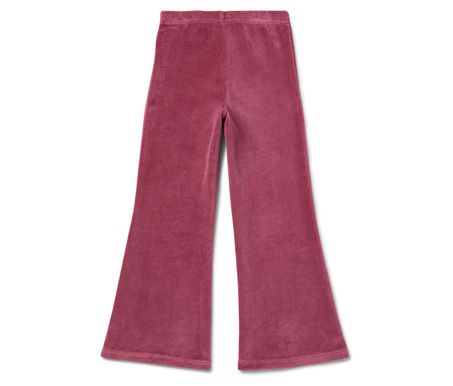 Un pantalon en velours côtelé rose évasé posé sur un fond blanc.