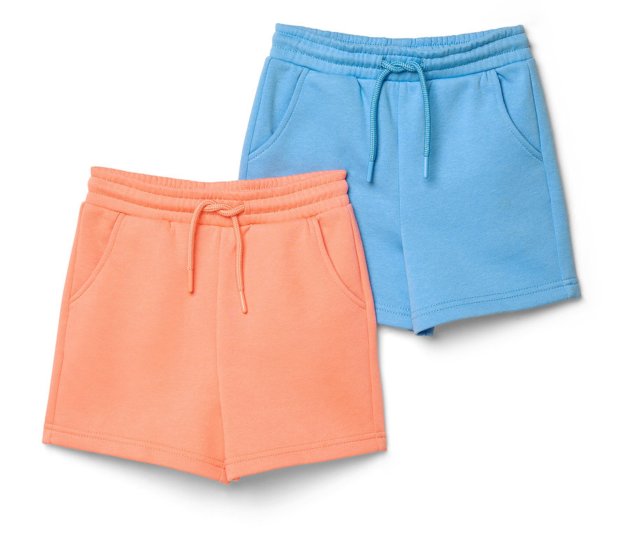 Deux shorts en molleton pour enfant avec intérieur gratté: un pêche et un bleu clair, tous deux avec taille élastique, cordon de serrage et poches.
