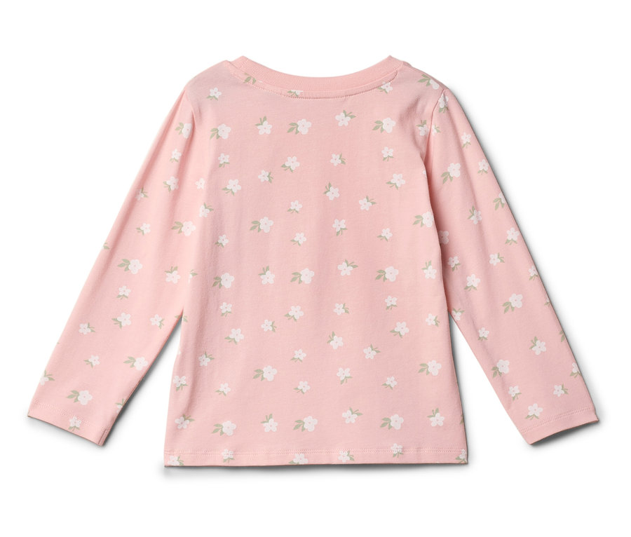 Haut à manches longues rose clair avec motif floral blanc.