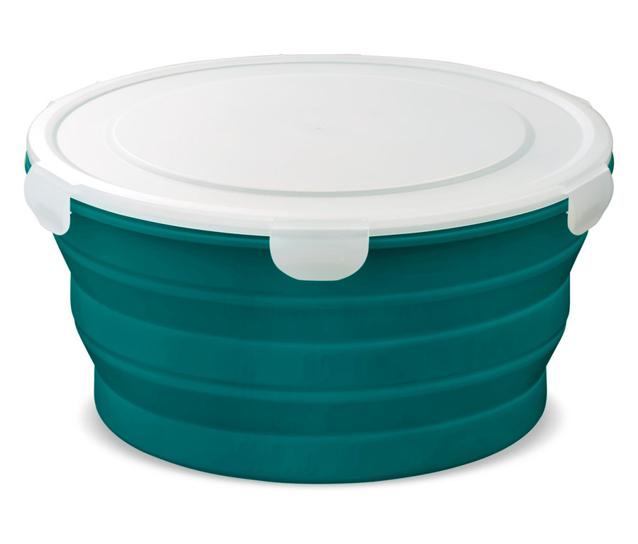 Un récipient vert, rond et pliable avec un couvercle blanc posé sur une surface blanche.