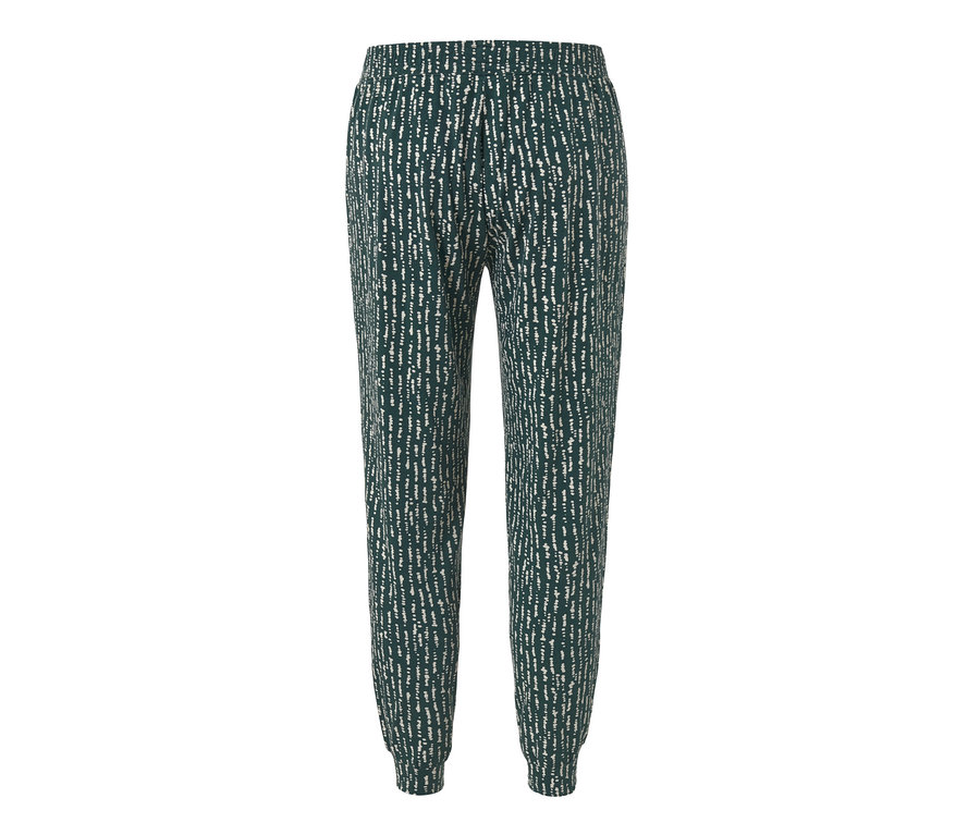 Le pantalon relax présenté a un fond vert foncé avec un motif blanc.