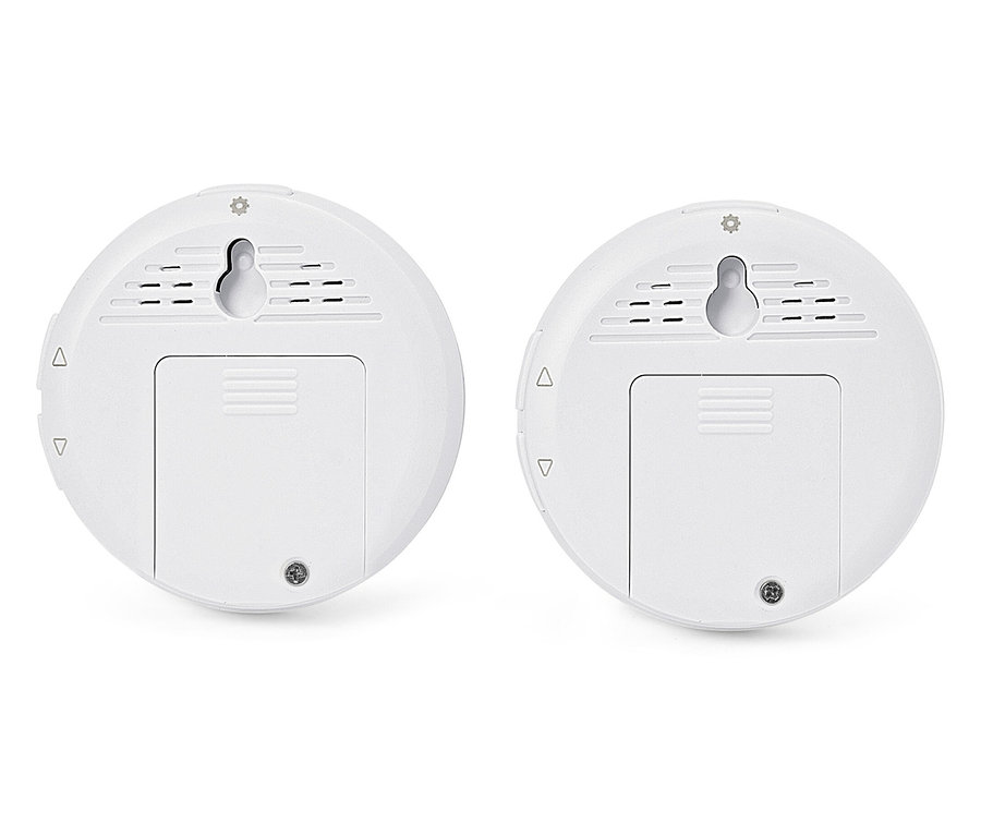 Deux capteurs ronds blancs avec supports muraux et couvercles de compartiments à piles.