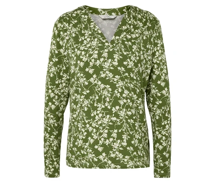 Chemisier vert à manches longues avec motif floral blanc.