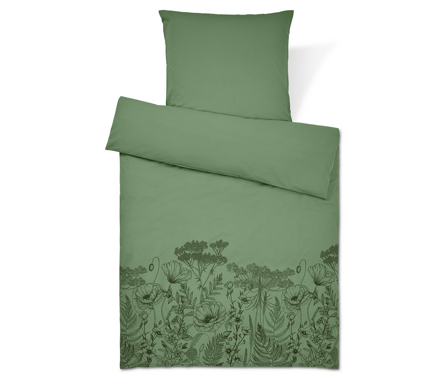 Literie verte avec motif floral. Oreiller en haut.