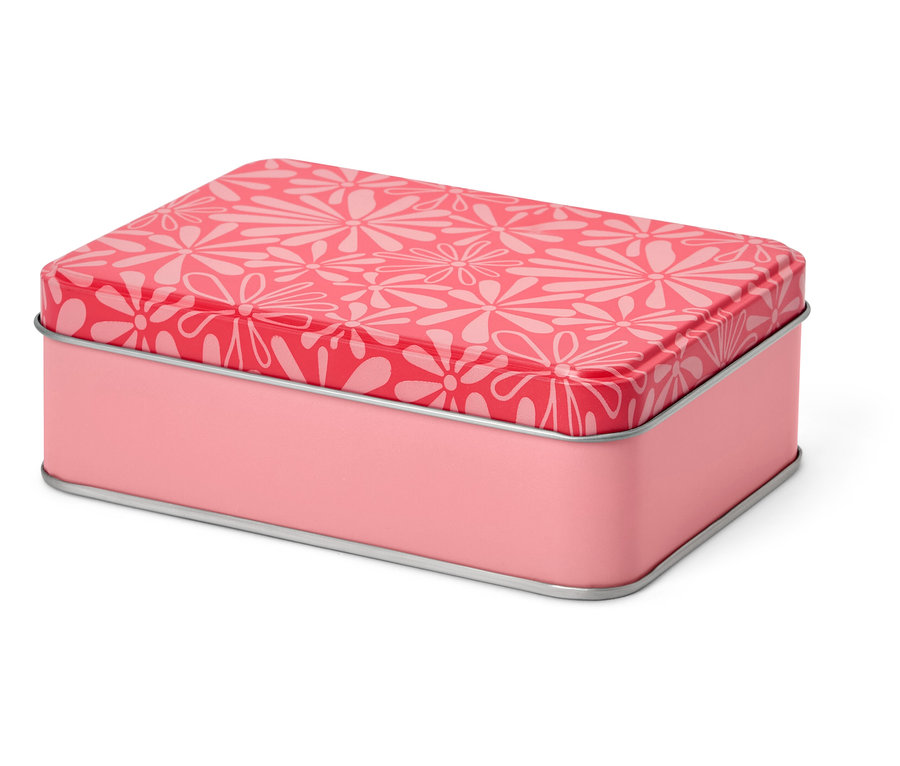 Boîte à couture rose en métal avec motif floral.