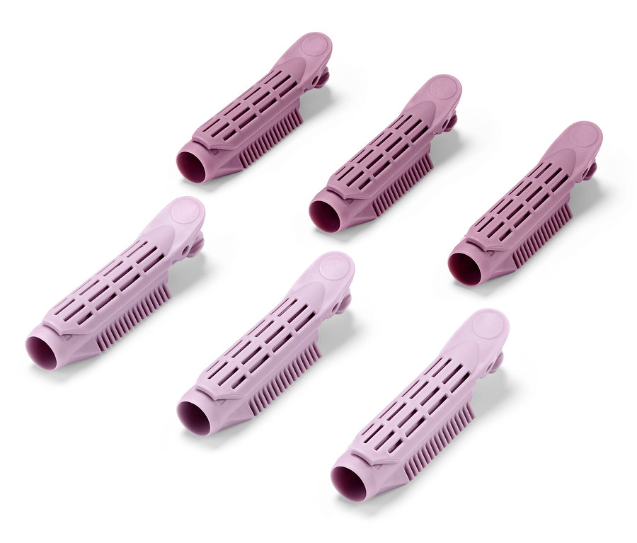 Six clips de volume roses pour les racines sur fond blanc.
