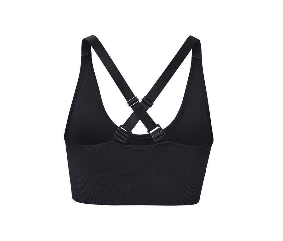 Détail d'une brassière de sport Seamless noire avec bretelles croisées.