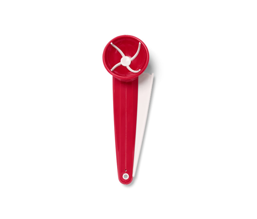 Une portionneuse de biscuits rouge avec des éléments blancs sur un fond blanc.