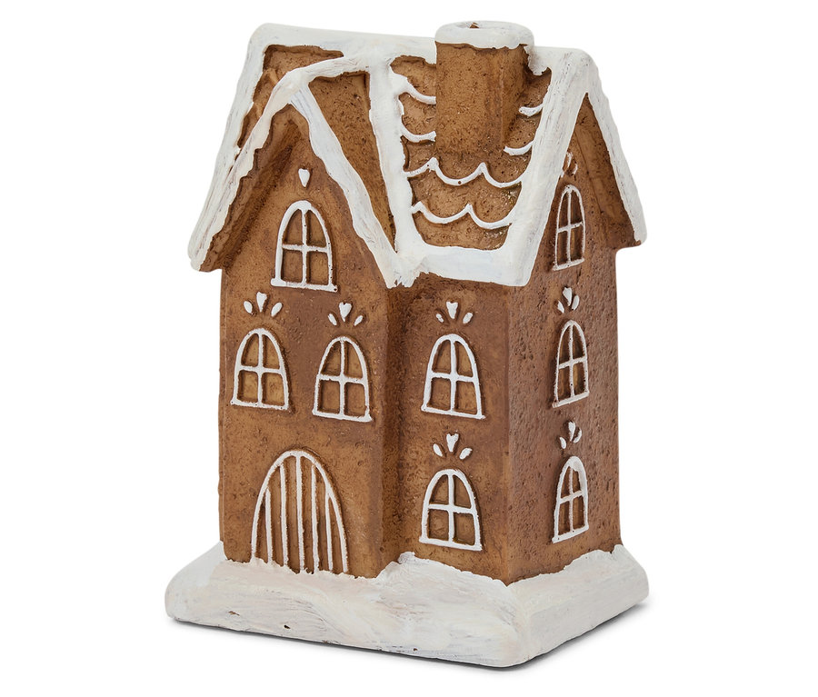 Gros plan sur une maison en pain d'épices marron avec un glaçage blanc sur les fenêtres et le toit.