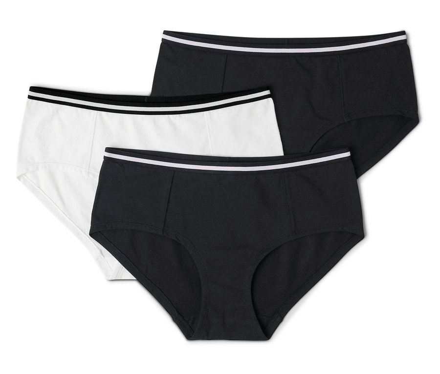Trois culottes pour femmes, une blanche et deux noires, toutes avec une ceinture blanche, sont superposées.