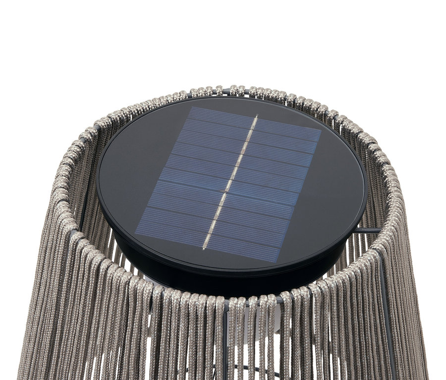 Gros plan d'une lampe solaire avec une corde tressée et un panneau solaire noir sur le dessus.