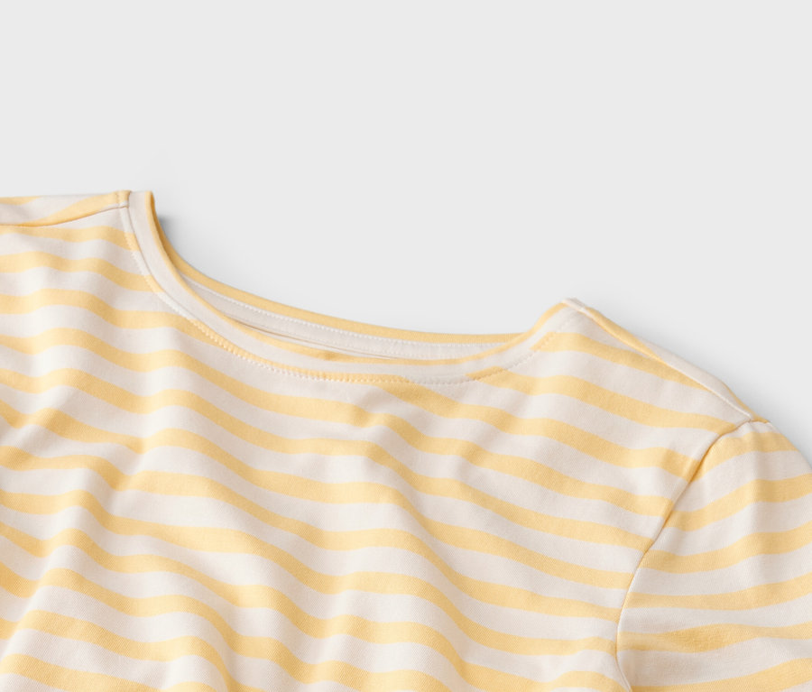 Gros plan sur un t-shirt à rayures jaunes et blanches avec un col rond.