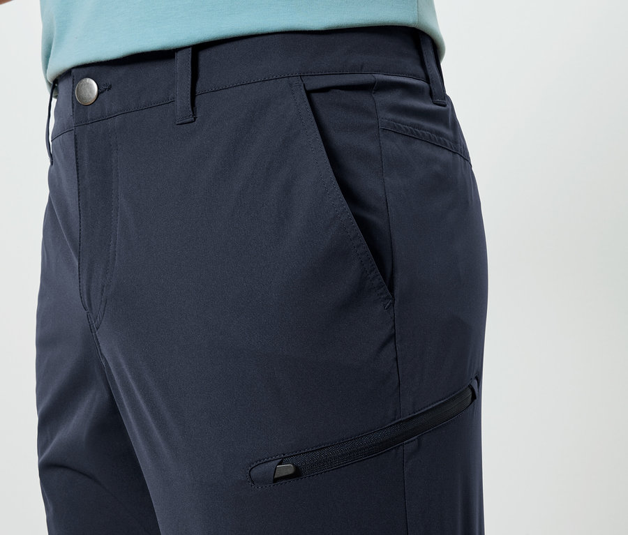 Gros plan sur un pantalon bleu marine avec une poche et une fermeture éclair.
